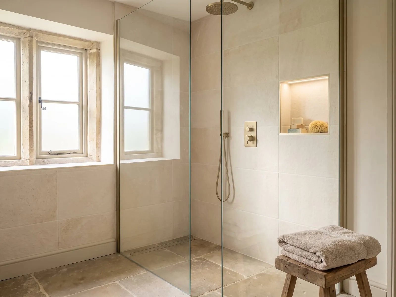 Walk-in shower in the finished bathroom, with a concealed valve and a tiled recess