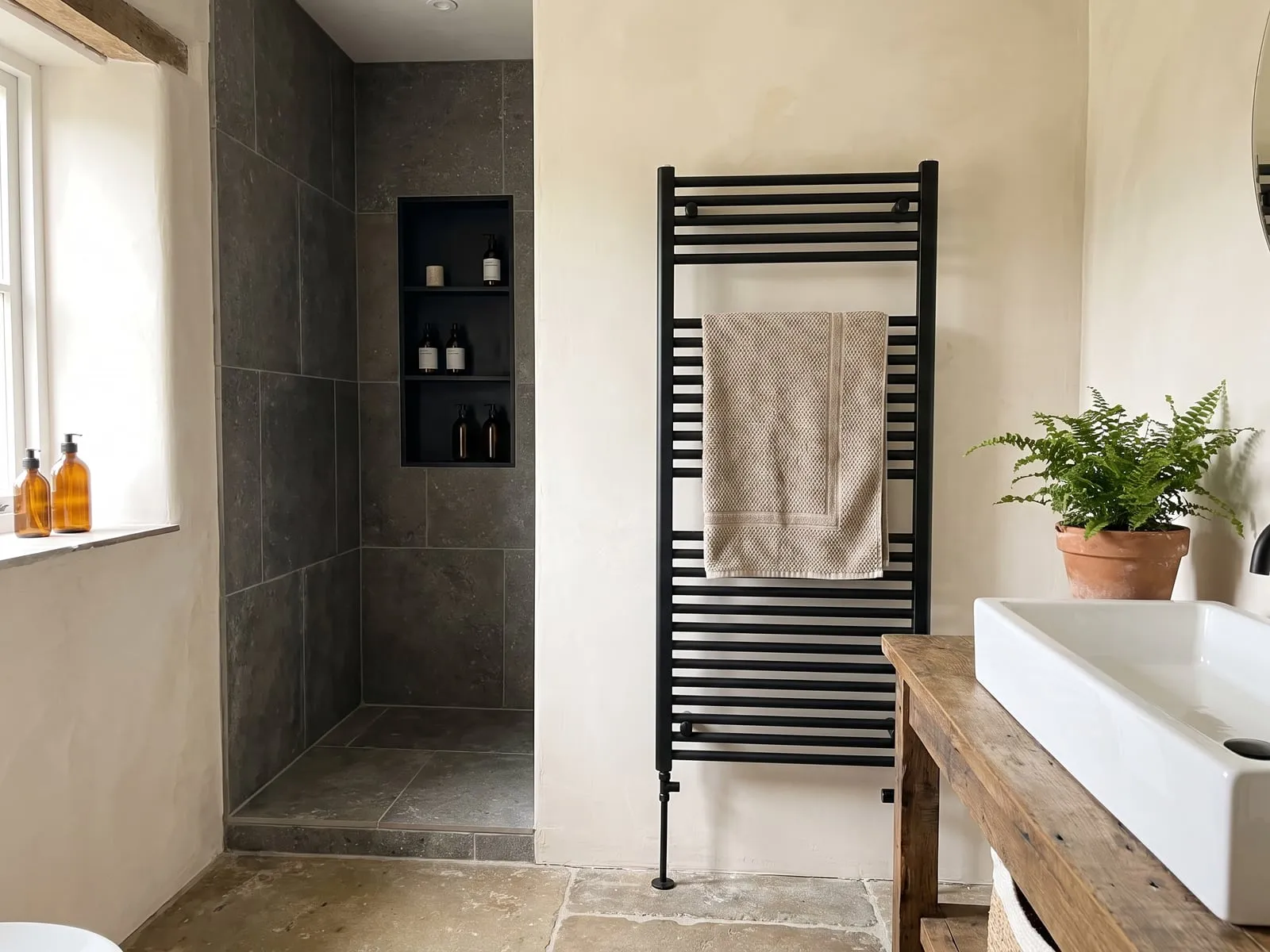 Walk-in shower with a tiled recess and planting alongside